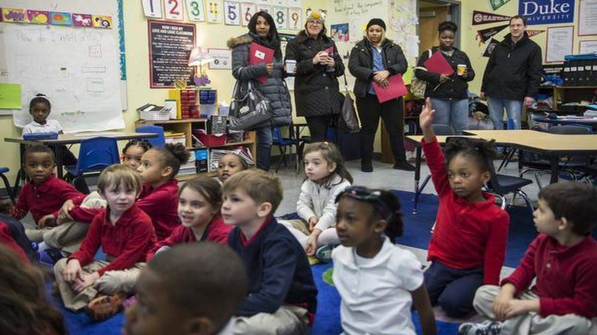 
Parents Shenia Davis (background, from left), Taylor Gass, NaTasha Conner, Tonisha Alexander and Chris Davis visited a kindergarten class at Crossroads Academy charter school in downtown Kansas City as part of a tour of five charter schools. The parents will soon be making school choice decisions for the fall semester. 
