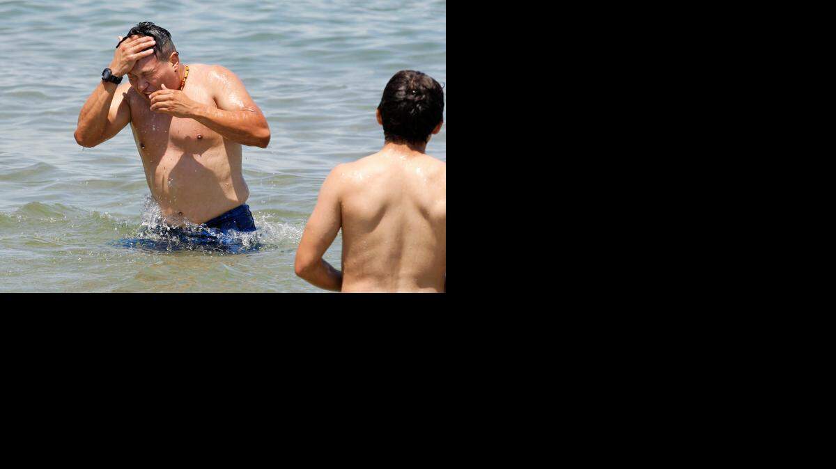 
Diving into Lake Michigan on Friday brought chilling shivers rather than cool relief to Gerald Alban, 22.



