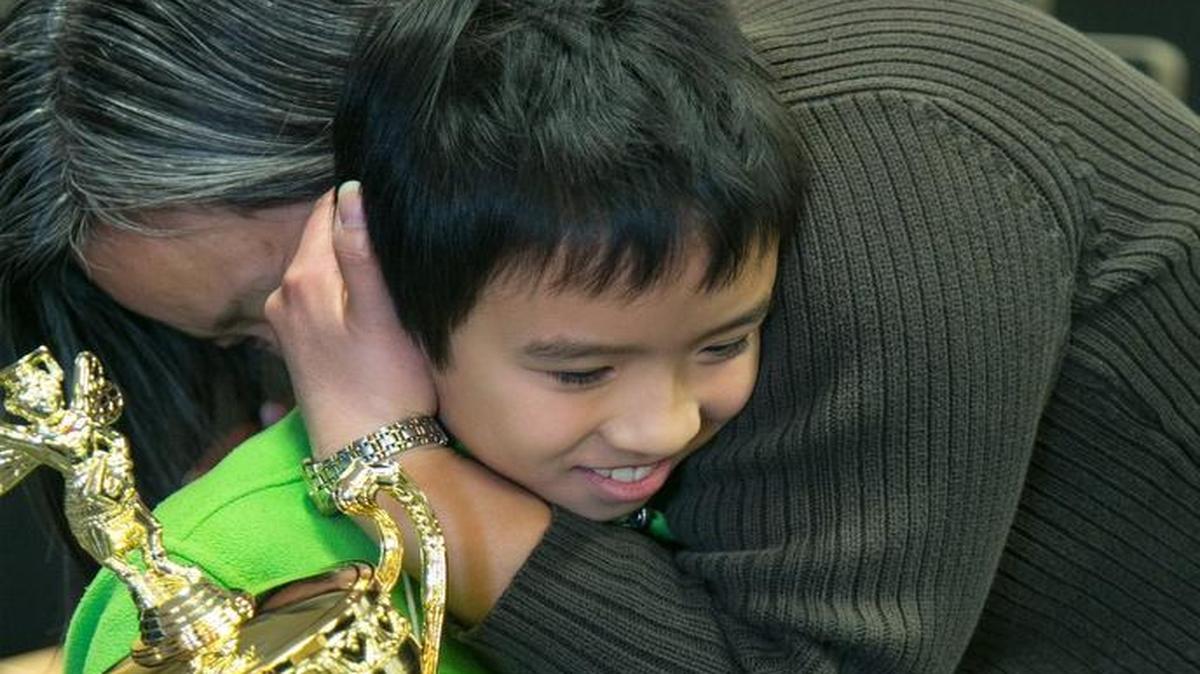 David Lye, a fifth-grader at Sunnyside Elementary School, got a hug from his mom, Kelly Vuong, after he won the Olathe Public Schools Spelling Bee at Frontier Middle School on Thursday.