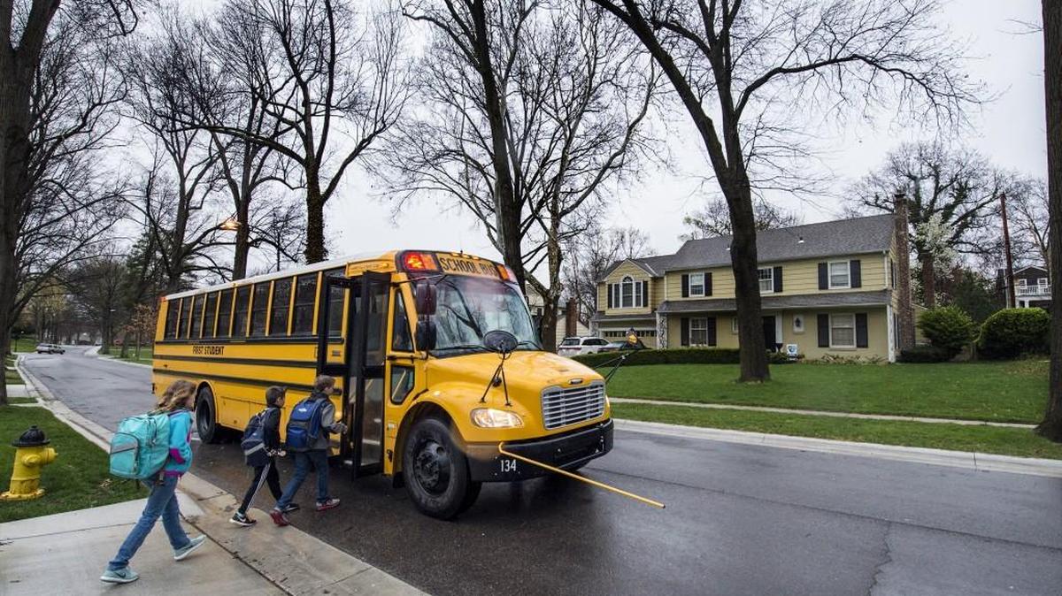 Children board the school bus on Thursday, March 24, 2016, in Mission Hills. Kansas law prohibits passing school buses, but drivers illegally pass buses by the thousands, a new survey shows.