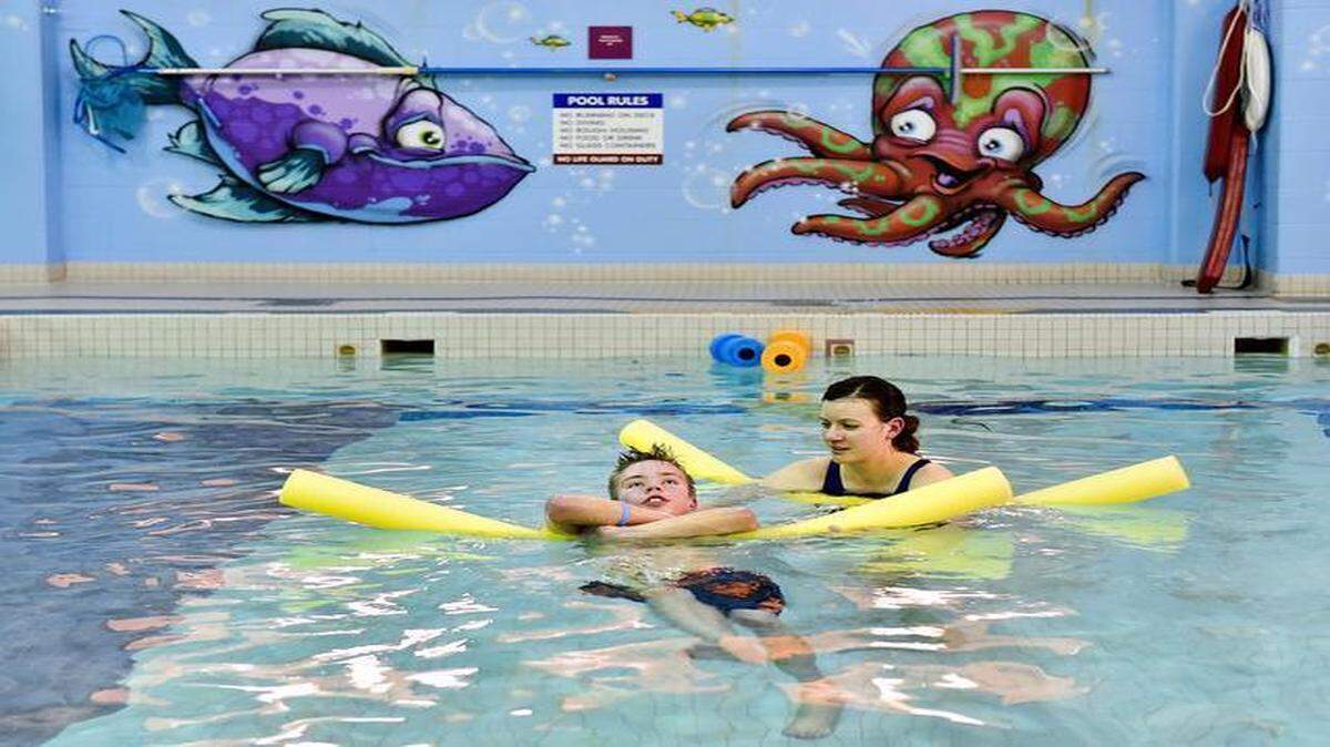 
Among about 100 youngsters who developed a mysterious paralysis is 13-year-old Billy Sticklen. But with physical therapy after his September illness, he has advanced from using a wheelchair to a walker and now a cane. On Wednesday he had pool therapy at Children’s Mercy Hospital with therapist Kelly Grabendike.
