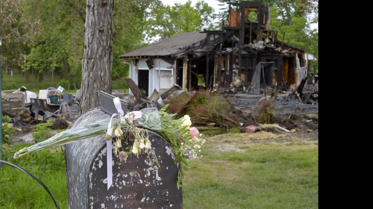 
Flowers were left on the mailbox last week at the scene of a house fire where two bodies were found in the 3400 block of W. 239th Street in Miami County, Kan.
