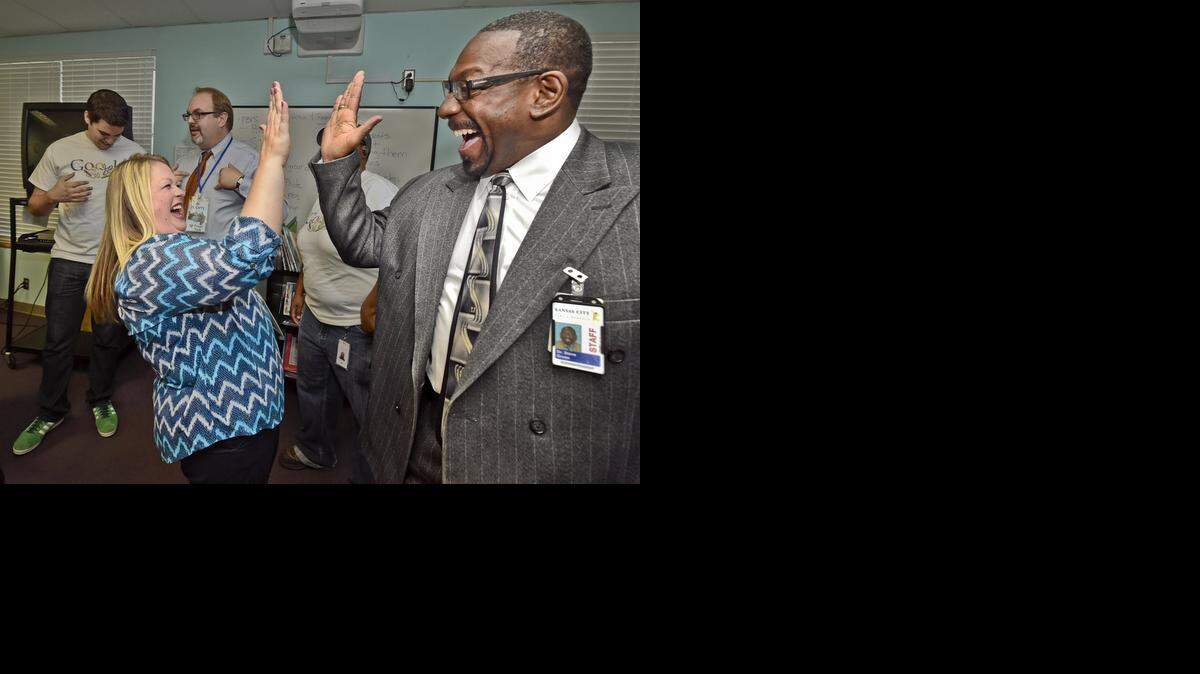 Annette Rhinehart, a fifth-grade teacher at Garfield Elementary School, celebrated Wednesday with Kansas City Superintendent Steve Green after hearing Google will fund all the current teacher requests on DonorsChoose.org in a 16-county area.