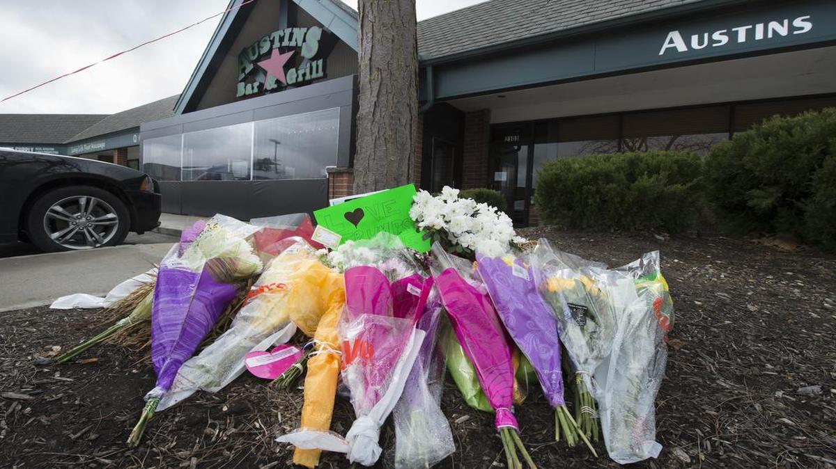 Bouquets of flowers formed a makeshift memorial outside of Austins Bar & Grill in February in Olathe. Three people were shot, one fatally, in the bar.