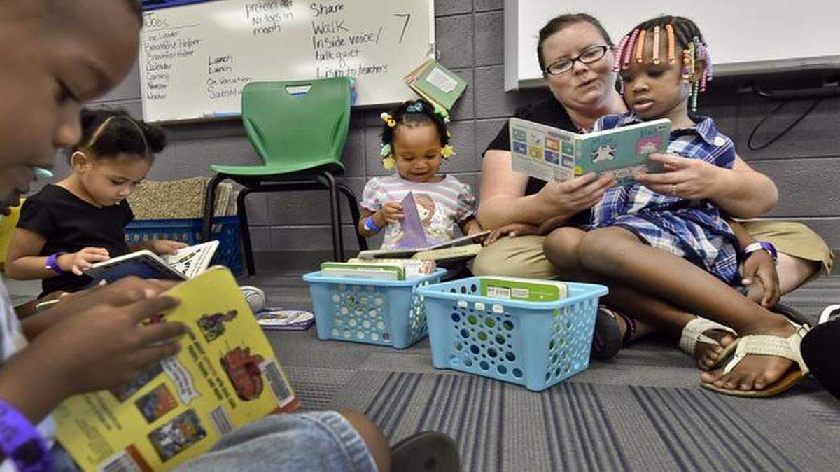
Pre-kindergarten teacher Jennifer Maddux read to Avion Jones, 4, at Hickman Mills’ Ervin Early Learning Center. The other students are (from left) 4-year-olds Octavious Bryant and Leah Morrisey, and 3-year-old Neveah Gatson. 


