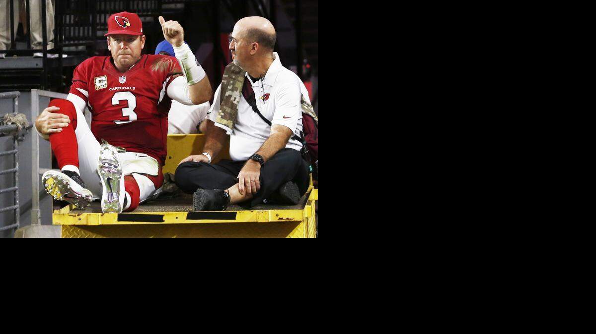 
Arizona Cardinals quarterback Carson Palmer leaves the field on a cart holding his right knee following an injury during an NFL football game against the St. Louis Rams on Sunday, Nov. 9, 2014 in Glendale, Ariz. 

