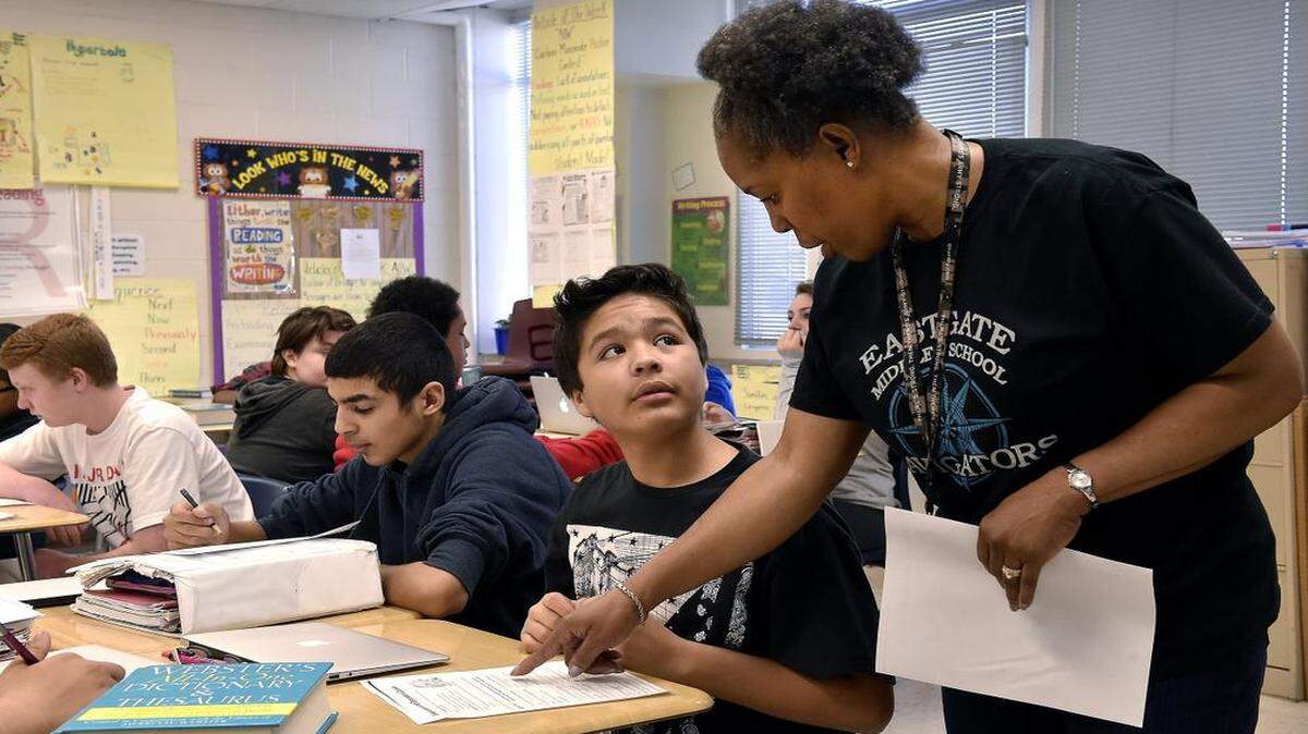 
Denairian Johnson, a language arts teacher at Eastgate Middle School, moves freely around her classroom to answer questions and give specific instruction to individual students. She helped seventh-grader Brayan Rocha during a recent session at the school.
