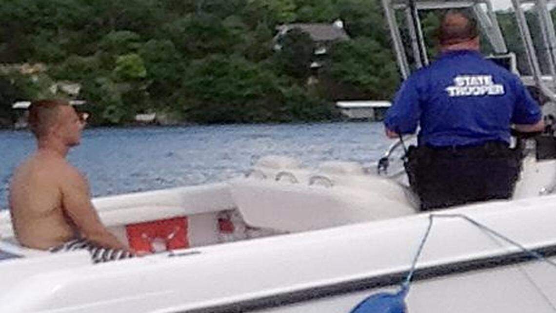 
During Brandon Ellingson's arrest on May 31, one of his friends took this photograph before Trooper Anthony Piercy put handcuffs on him. Then, the friends said, they watched the trooper pull a Type III life vest over Ellingson's head. Experts say Piercy should have used the Type I or II life jacket that is visible inside the boat.
