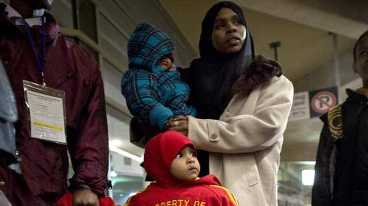
Even before leaving Kansas City International Airport on Thursday for their new home, Somali refugees Samra Ilme Hassen (center) and her family had received help in the form of warm clothes from nonprofit Della Lamb. Parents Ilme Hassen Bashir (left) and Naima Dawid probably will find significant support from the local Somali community.
