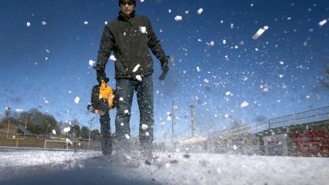 William Jewell College head track coach Tom Eisenhauer turned a leaf blower into a snow blower on Monday, Jan. 18, 2016, as he cleared a running lane for his athletes to practice on later in the day.