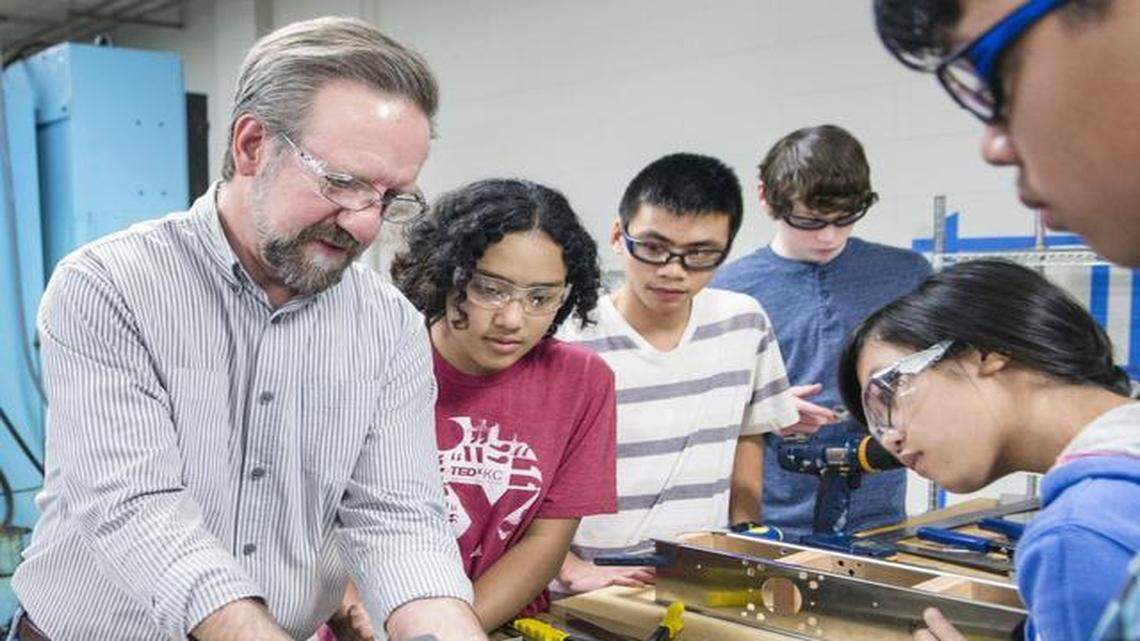 
Engineer mentor Ivan Helmrich helps Lincoln Prep students Kara Richardson (clockwise from left), Steve Thatsanithone, Taylor Corn, Thao Duy Nguyen and Viet Nguyen work on a robot at the KC Engineering Zone at the University of Missouri-Kansas City. 
