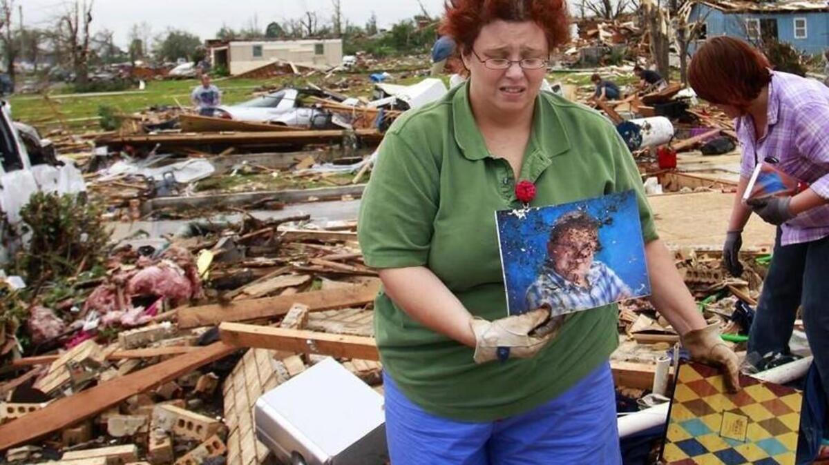 Tammy Niederhelman held a photo of her son Zachary Williams that she found while digging through what was left of her home after the 2011 Joplin tornado.