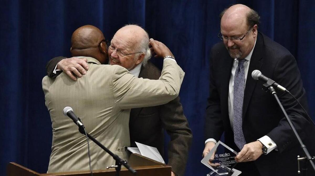The Rev. Vernon Percy Howard Jr. (left) and the Rev. Robert Lee Hill (right) were nearby as the Rev. Sam Mann received his award Sunday.