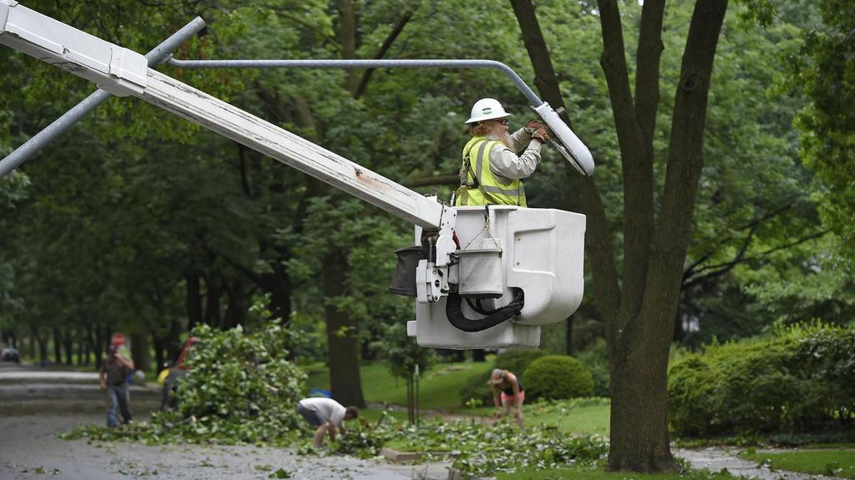 
Victor Kimmi, journeyman lineman with Black & McDonald, removed a city light pole bent over 57th Street near Pennsylvania Avenue after strong storms moved through Kansas City early Friday. 
