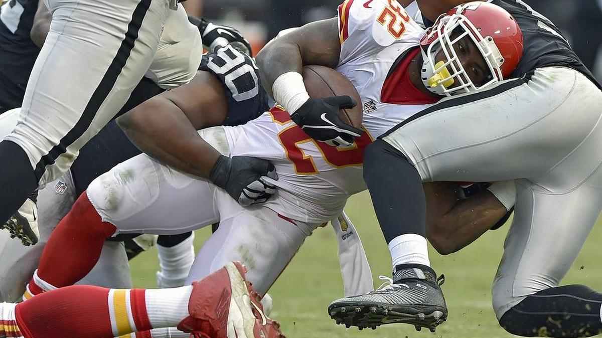 Kansas City Chiefs running back Spencer Ware (32) stretches for extra yardage in the third quarter during Sunday's football game against the Oakland Raiders on December 6, 2015 at O.co Coliseum in Oakland, Ca.