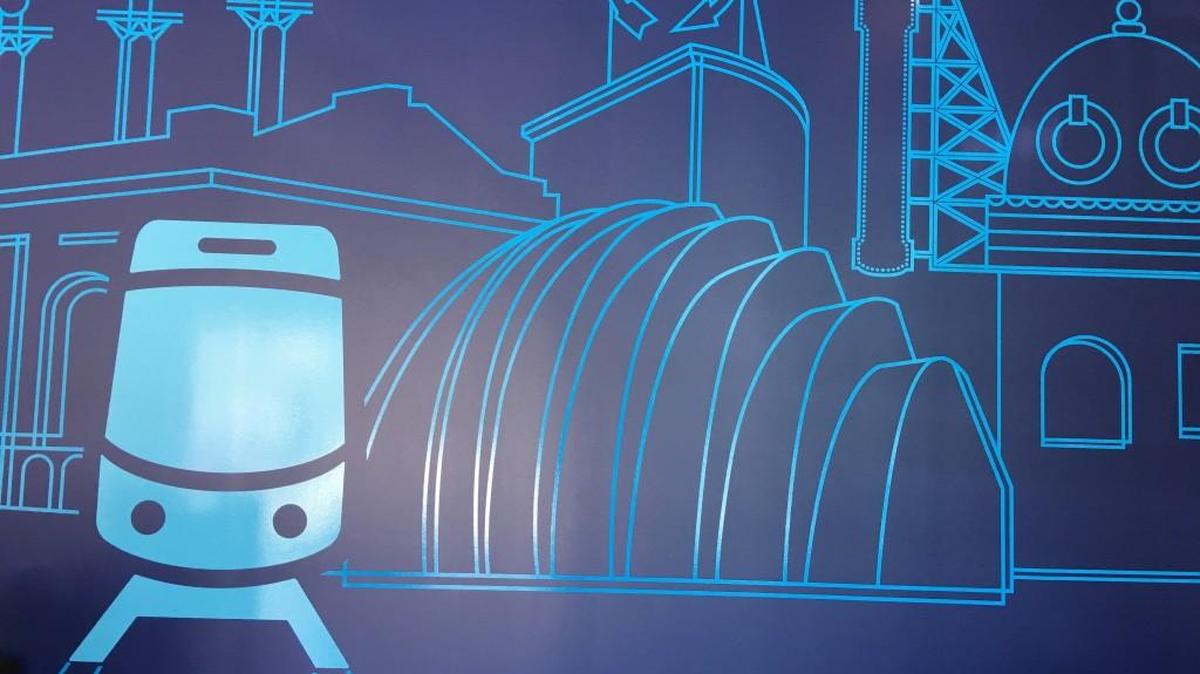A floor-to-ceiling graphic at the Kansas City Streetcar Authority celebrates the starter route’s role on the city’s economic development scene.