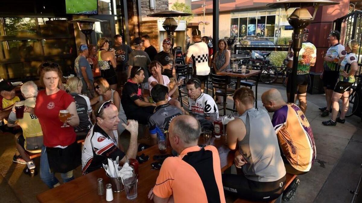 A group of cyclists lounge on Rock & Brews’ spacious patio.