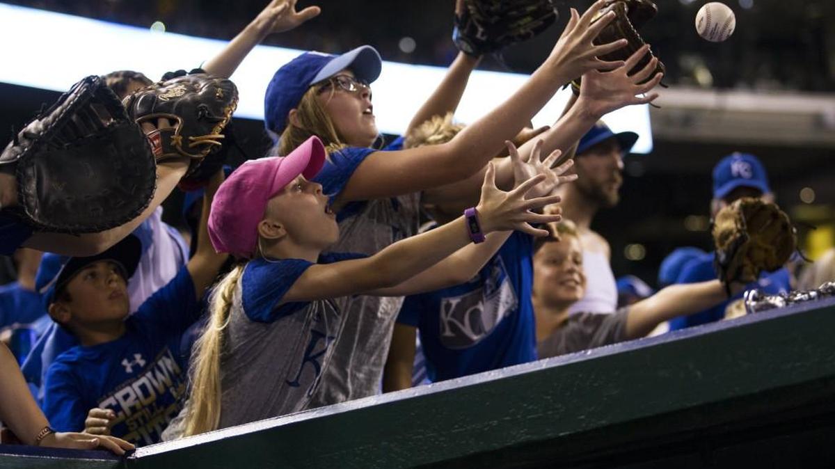 Among the 2 million-plus fans flocking to Kauffman Stadium this year were 13-year-old Addison Brooks (blue hat) of Norton, Kan., who reached past 9-year-old Hallie Brooks (pink hat) to catch a ball tossed by a Royals player at a game in August.
