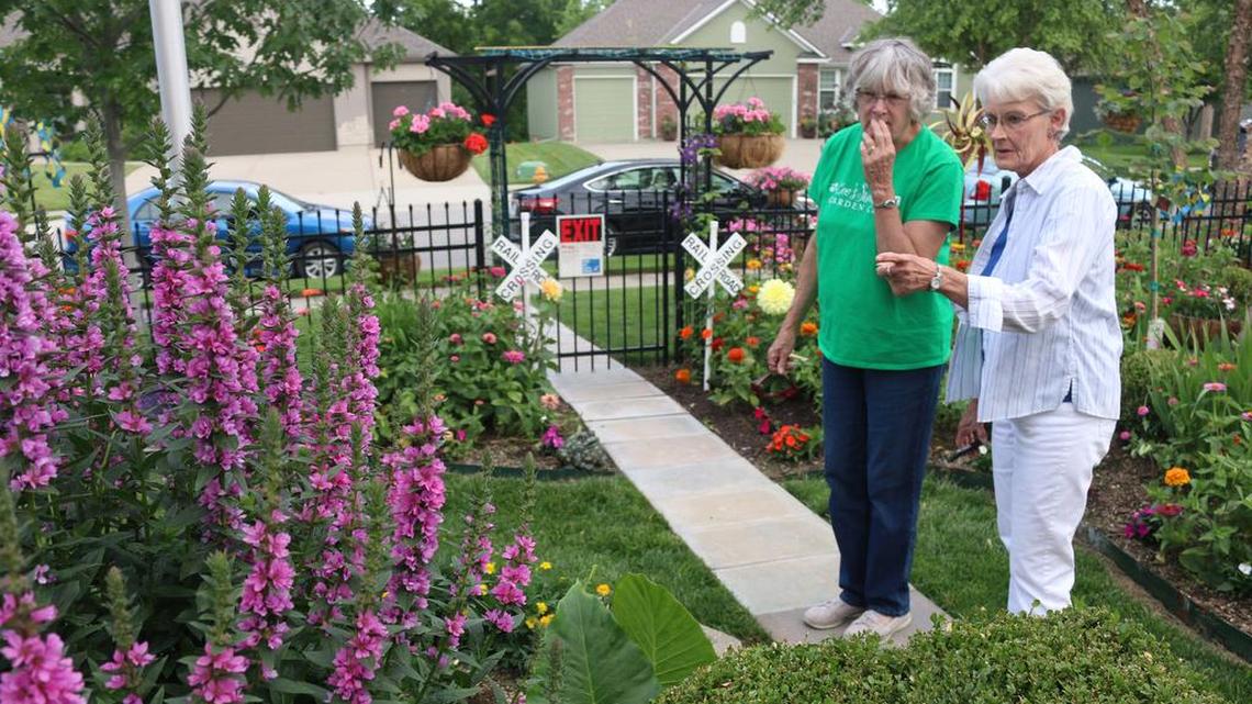 Sharon Sommer of Pleasnt Hill and Kaye Morris of Lee’s Summit discuss the flowers during as tour of Bob and Frances Schmuck’s garden in Raymore.