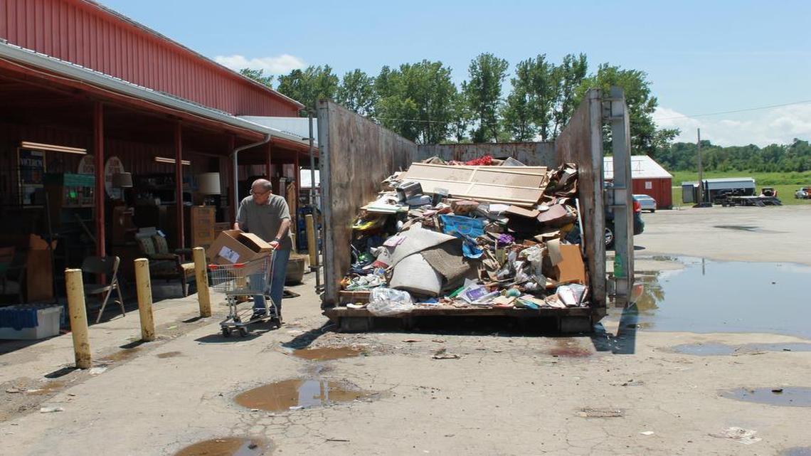 Volunteers filled at least 10 dumpsters with damaged goods from Trade Fair Mall in Harrisonville on Friday, July 28, 2017. Tens of thousands of dollars worth of equipment and goods were damaged as a result of flash flooding that occurred on Thursday, July 27, 2017 in the Kansas City region.