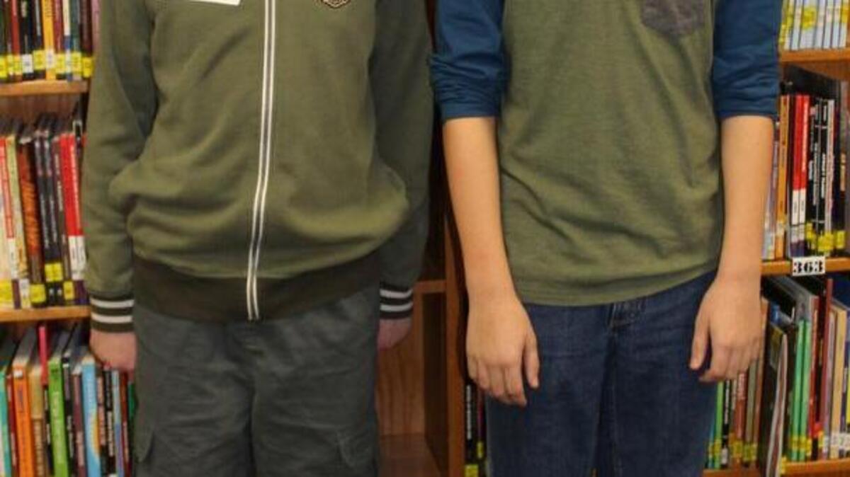 Harrisonville Middle School eighth-grader Tyler Kimbell (right) won the district’s spelling bee. The runner-up was Quincy Carter (left).