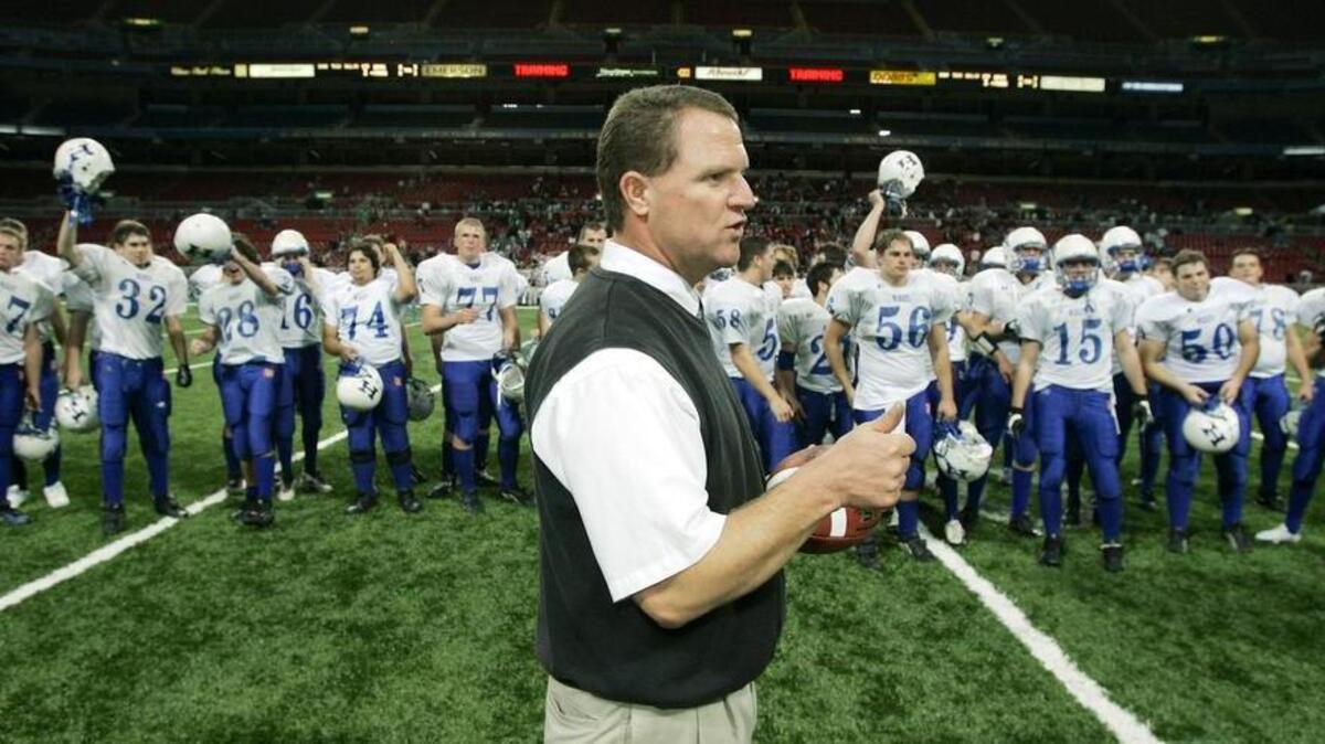 John Sleezer/The Kansas City Star 11/26/05 2005 (With Sports Story) Harrisonville head coach Fred Bouchard gives a thumbs up as his team celebrates their state victory after Saturday’s November 26, 2005 Missouri Class 3 State football game between Harrisonville and MICDS at the Edward Jones Dome in St. Louis, MO.    Taken at 5.0,Shutter Speed 1/320, White Balance of Custom, ISO of 640, at 7:54:25 PM on 11/26/2005.

cutline: Coach Fred Bouchard of Harrisonville High School offered a thumbs-up in front of his celebratory squad following the Wildcats’ 42-0 shutout over Mary Institute County Day School. In the Class 3 game, played Saturday at the Edward Jones Dome in St. Louis, Harrisonville established a state record for all classes by holding the MICDS offense to just 32 yards.