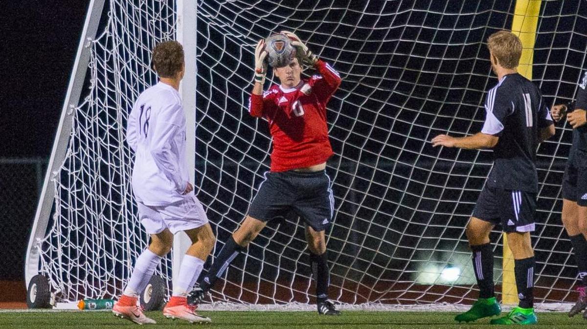Raymore-Peculiar goalkeeper Grant Hutchings reaches up to make a save against Lee’s Summit Tuesday night. Ray-Pec beat the Tigers 3-1 at Bud Hertzog Stadium.