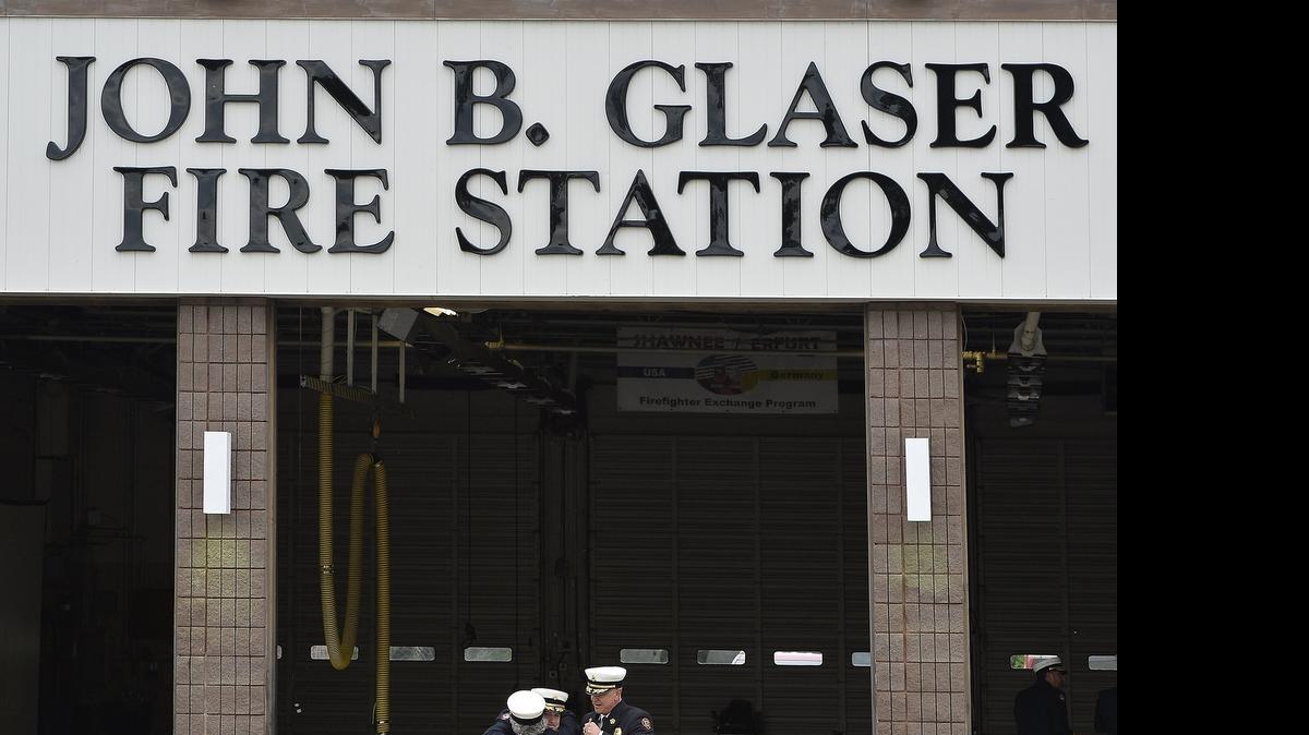 
After unveiling a new sign on the station, the captains or battalion chiefs who were on duty the night Glaser died shared a hug.


