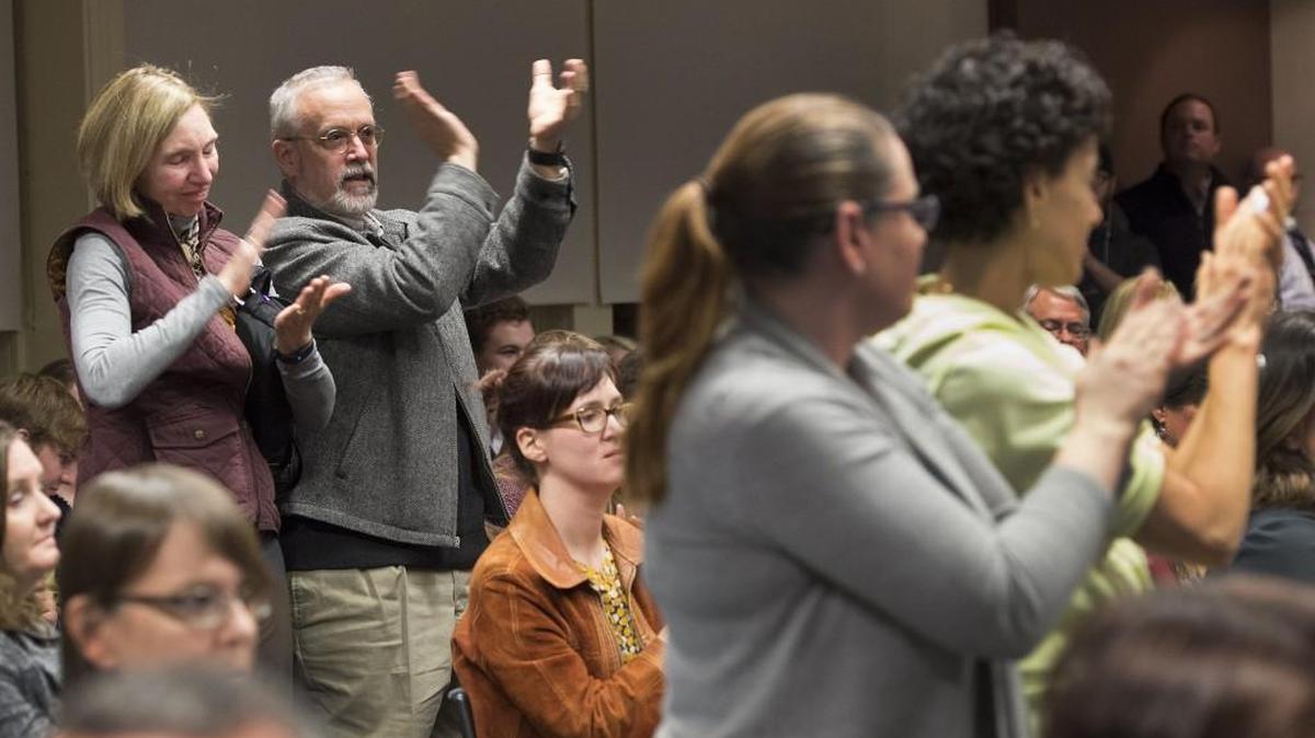 Susan and Tim Norris of Lenexa applauded as a speaker encouraged the Shawnee Mission School Board to reverse their ban on teachers and staff wearing safety pins at a November 2016 school board meeting. A new board policy enacted this week states that speakers who address the board cannot complain about individual board members or school employees.