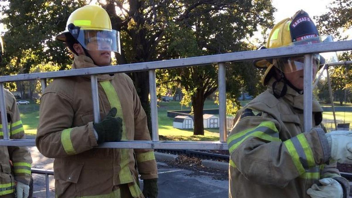 Skyler Rhoads (left) and Jacob Simma carried a ladder during a fire-science lesson.