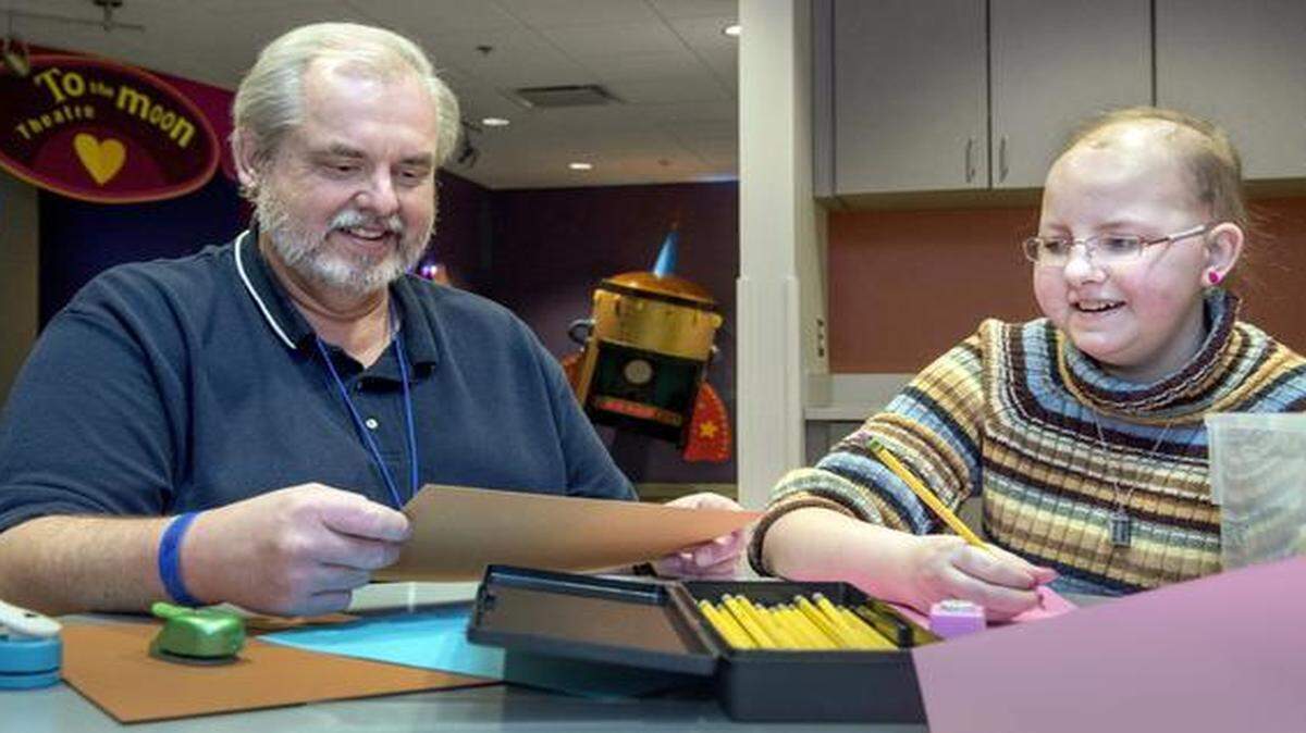 
Among the first to stay at the new Ronald McDonald house is the James family from Carthage, Mo. Here Ed James and his 14-year-old daughter, Bethany, work on a project. Bethany’s family has stayed at several Ronald McDonald Houses over the years.
