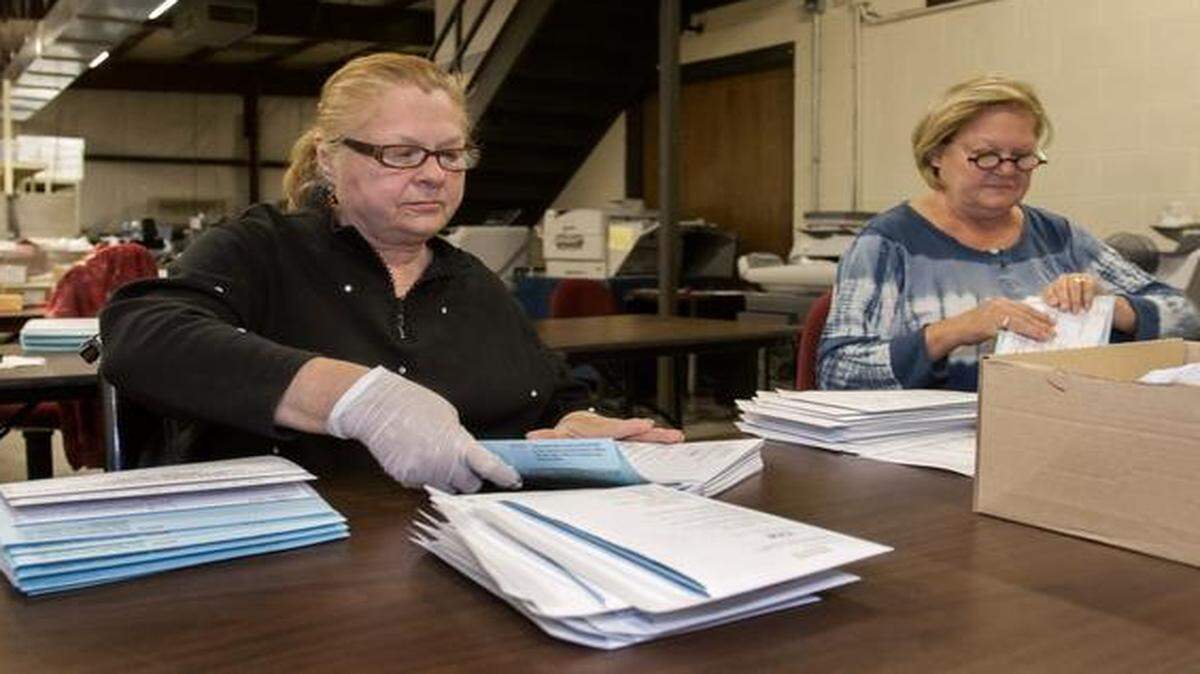 
Preparations for the Nov. 4 general election were in full swing Tuesday at the Johnson County Election Office, 2101 E. Kansas City Road in Olathe. Sisters Lee Anne Snozek of Olathe (left) and Clariessa Sessel of Overland Park prepared advance ballots for mailing.
