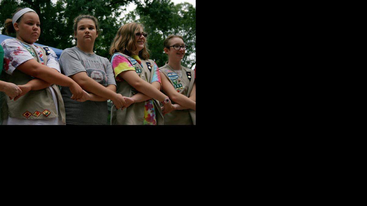 Cadettes Phelan Daye, Caitlyn Riley, Alyssa Harmon and Libby Barker of Troop 1248 in Lee’s Summit join hands during a friendship circle after the Hodges announcement at Camp Prairie Schooner.