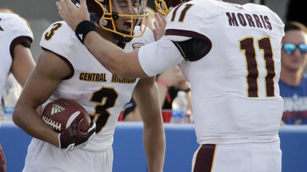 Central Michigan wide receiver Mark Chapman (left) celebrates with quarterback Shane Morris after the two hooked up for a 75-yard for a touchdown pass in the second half. Morris threw five TD passes against the Jayahwks.