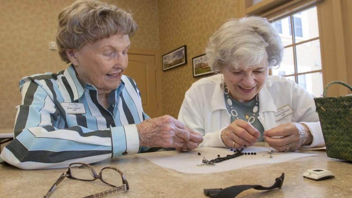 The Santa Marta Senior Living Community in Olathe aims to “resemble more of a resort atmosphere,” its directors say. Santa Marta is just one example of a growing number of options for senior living. Dotty Cosgrove (left) and Teresa Sittenauer made beaded straps recently for their alert bracelets.