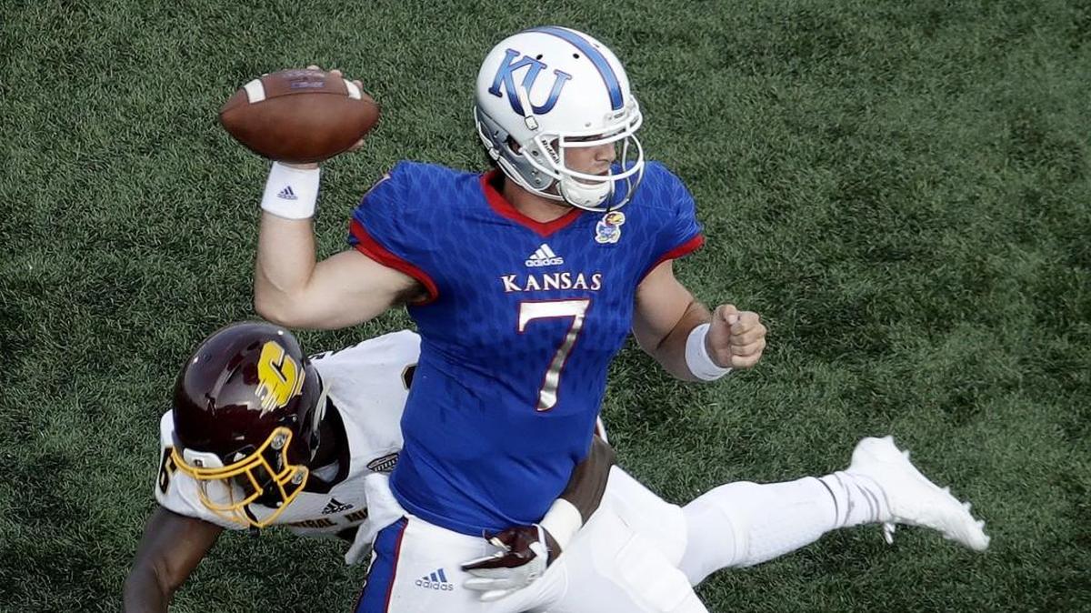 Kansas quarterback Peyton Bender passes under pressure from Central Michigan defensive back Da’Quaun Jamison during the second half.