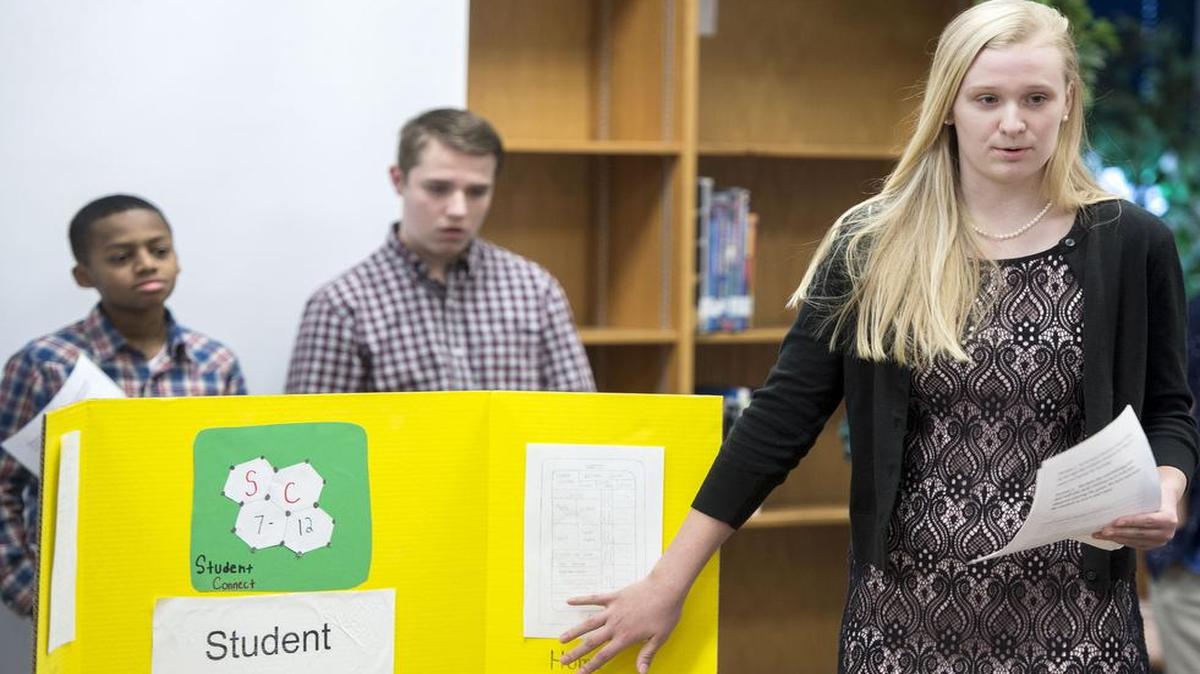 The Junior Achievement program encourages kids to learn important lessons of business and handling money. A “Shark Tank”-style competition at Indian Woods Middle School in Overland Park gives youngsters the opportunity to pitch their ideas to a panel of judges. Thirteen-year-old Amelia Tadko (right) touts her team’s “Student Connector” app. (Shawnee Mission district Superintendent Jim Hinson, who served as a judge, was so impressed by the team’s pitch that he contacted the district’s application design team to begin working with the students to make the concept a reality.)