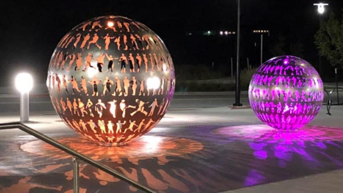Lenexa’s newest piece of public art, “Body Politic,” is now in place at the city’s civic campus on 87th Street Parkway. Lights change colors throughout the night inside the two hand-hammered stainless steel orbs fashioned by artist Joe O’Connell and his team from Creative Machines.