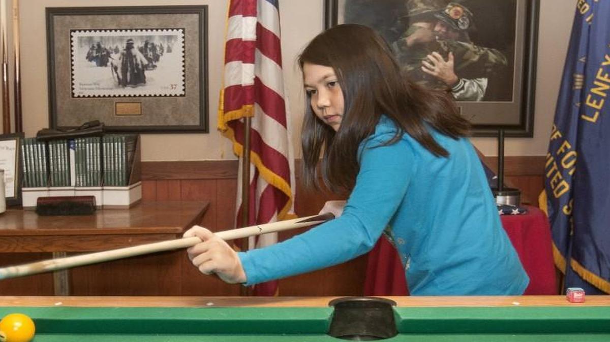VFW Post 7397 in Lenexa has intentionally opened its doors to several different groups in an effort to be a location that appeals to and serves the needs of all veterans. Angel Schuerman, 9, daughter of Ben Schuerman, plays pool during a recent beans and cornbread feed which included members of several veterans organizations.