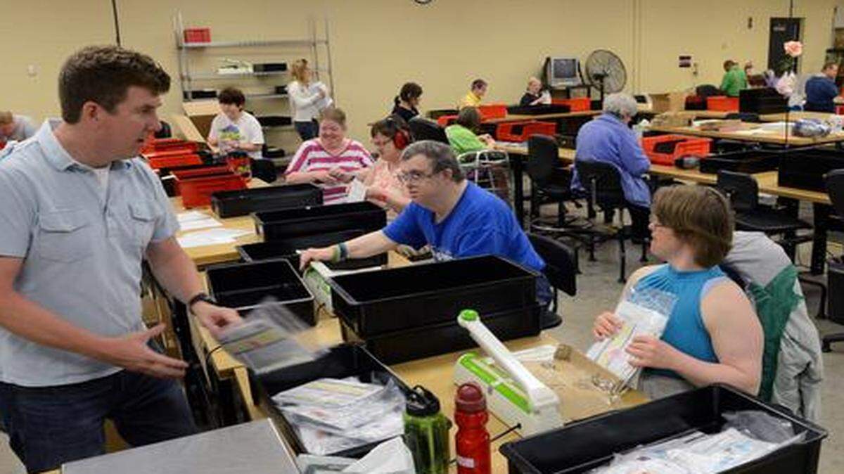 
Greg Aslinger (left) a senior direct support provider at Johnson County Developmental Supports, helps keep everyone on track and completes quality control checks at the Mark D. Elmore Center, 10501 Lackman Road, Lenexa.

 
