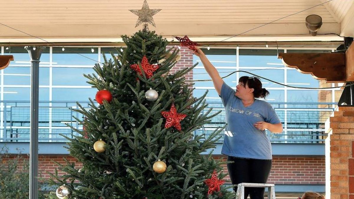 Overland Park has already begun its holiday fun, with the season having kicked off Nov. 18 with a tree-lighting ceremony. Kate Sweeten (top) and Ellie Haire, both with the Downtown Overland Park Partnership, decorated the Mayor’s Christmas Tree before the ceremony. “It’s a lot of advanced planning and a lot of extra hours (to) make sure everything is ready to go,” Sweeten says, but when Santa walks out and the kids burst with joy, it’s all worth it, she adds.