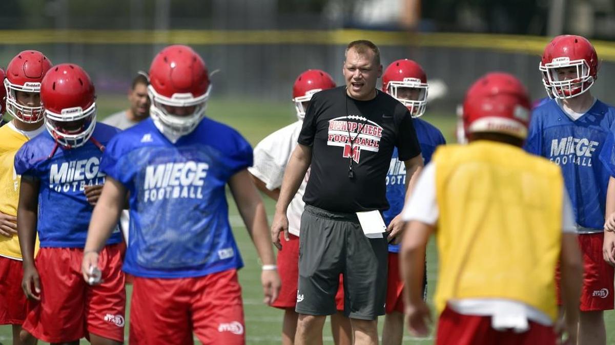 Bishop Miege High School coach Jon Holmes got his team organized during the first day of practice Monday afternoon at the school. Miege will be vying for a fourth-consecutive Class 4A-Division I state title this season.