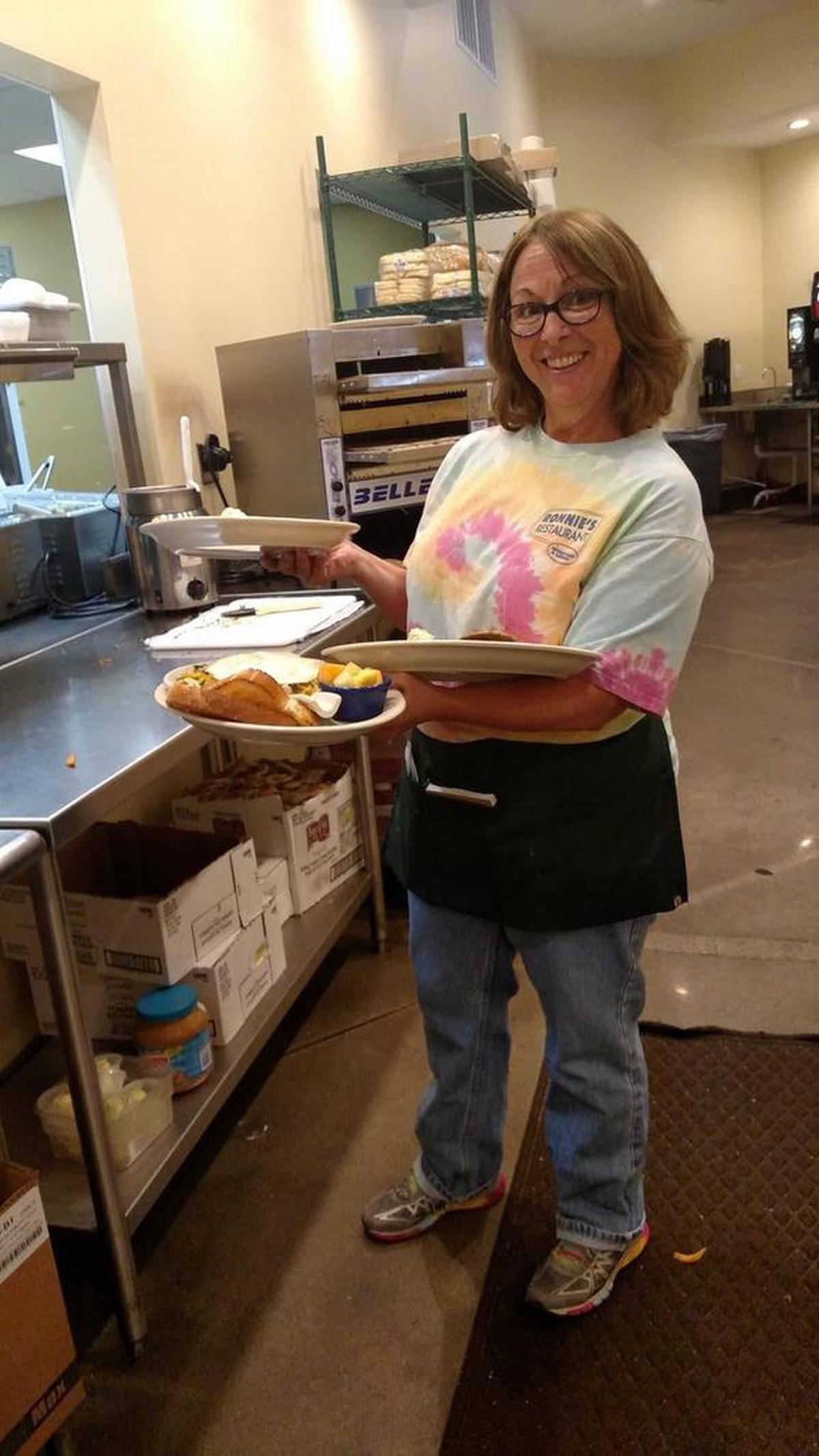 Robin Murphy, Olathe Northwest director of theater, took on a job as a waitress at Ronnie’s Restaurant in Lenexa. While she usually spends her summers traveling to see her kids, this year she’s focused on getting her youngest child through college.