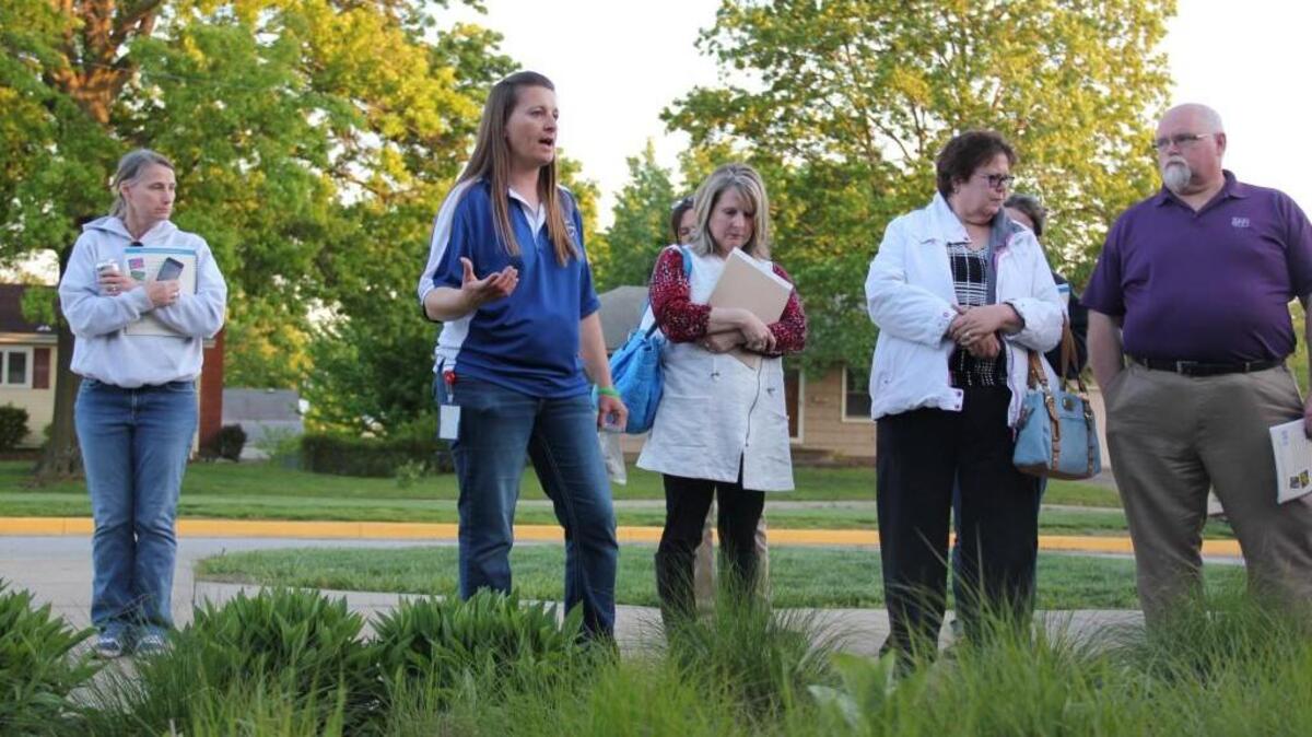 Marsha Skoczek, science teacher at Olathe North’s Geoscience Academy, talks gardening techniques with Johnson County residents May 4 at a rain garden workshop.