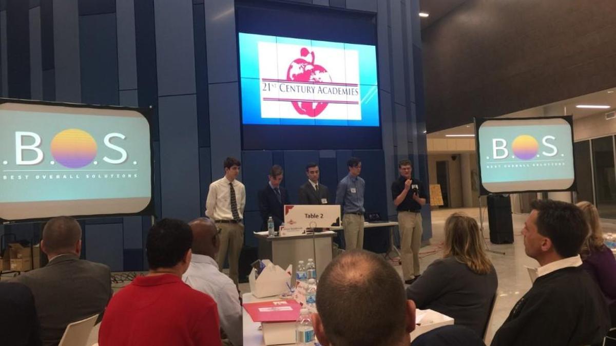 The first one shows team B.O.S. presenting to the Olathe School Board and the district professionals advisory board. The group from left to right is: Matt Reichmuth Tanner Williams, Holden Hartley, Cameron Wasinger and Isaac Taylor.