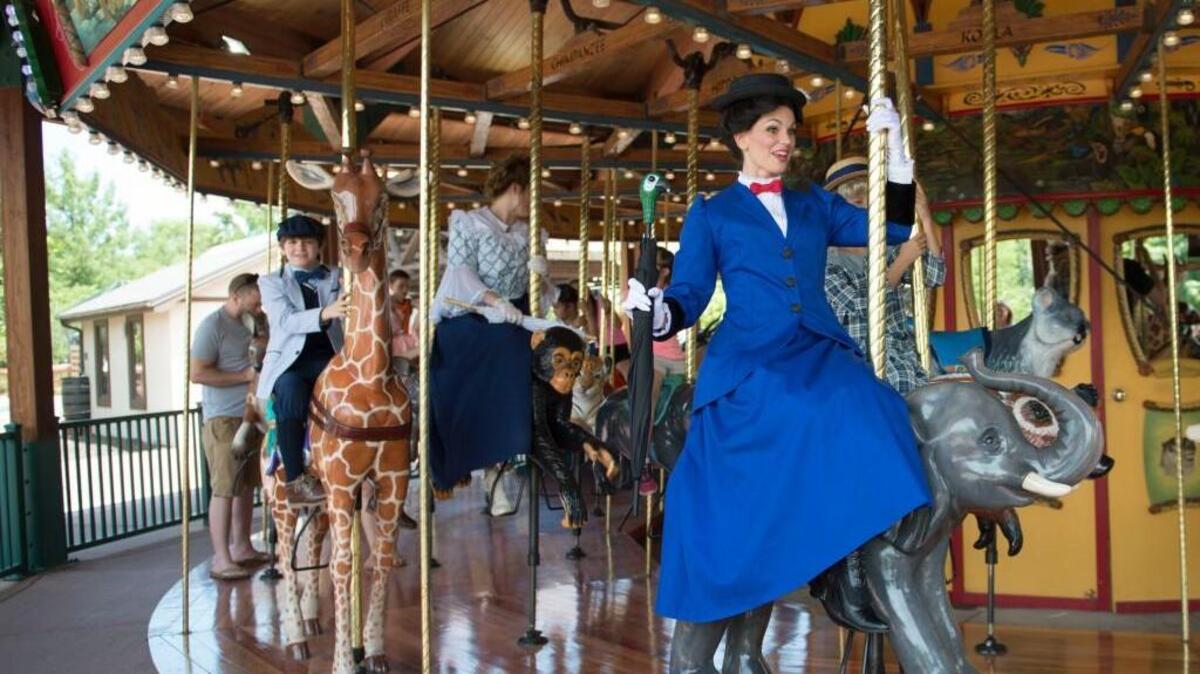 Mary Poppins, played by Jennifer Renfrow, rode the carousel as she and other “Mary Poppins” cast members made an appearance at the Kansas City Zoo on June 29. “Mary Poppins” opens tonight in White Theatre at the Jewish Community Center. The show will run at there until July 24. Its run will continue from July 29 to Aug. 6 at Theatre in the Park.