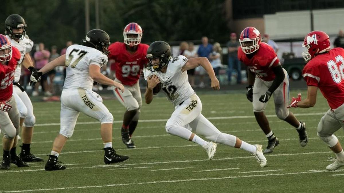 Quarterback Luke Bernard of Blue Valley finds some running room against Bishop Miege’s defense.