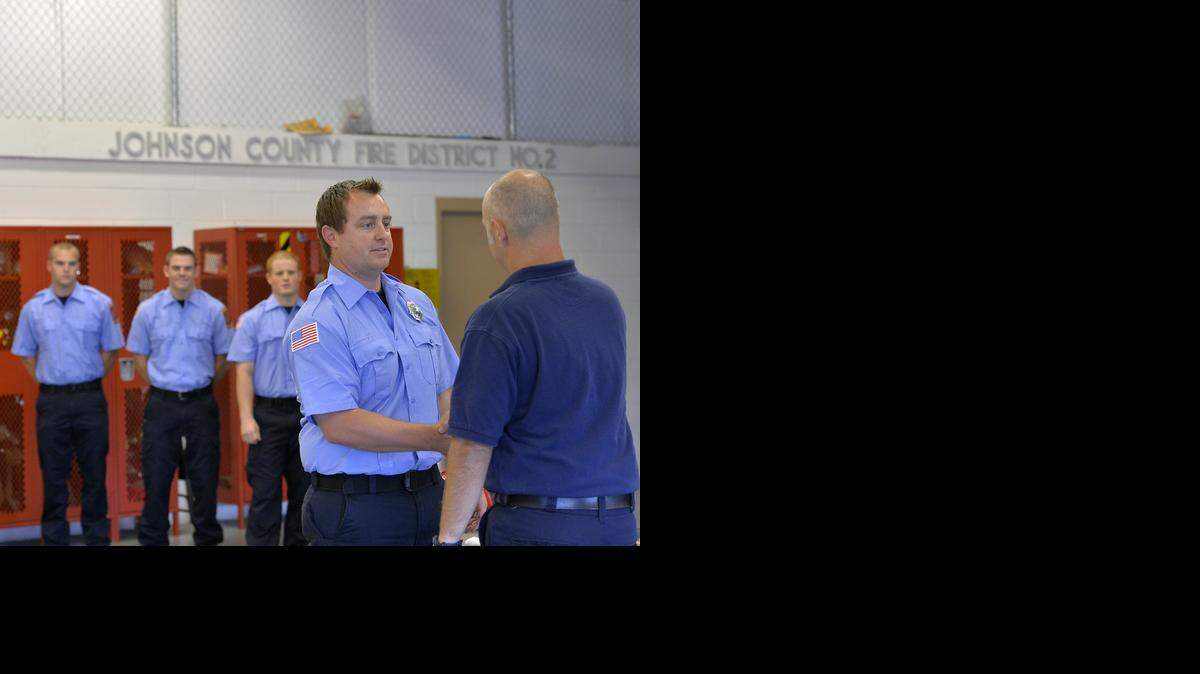 
With graduation comes the badge. And Johnson County Fire District No. 2 this summer held a graduation for volunteer firefighter recruits at its Spring Hill station. Capt. Brad Davis (right), coordinator of the volunteer program, congratulated recruit Scott Johnson of Overland Park after he pinned the badge on Johnson.















