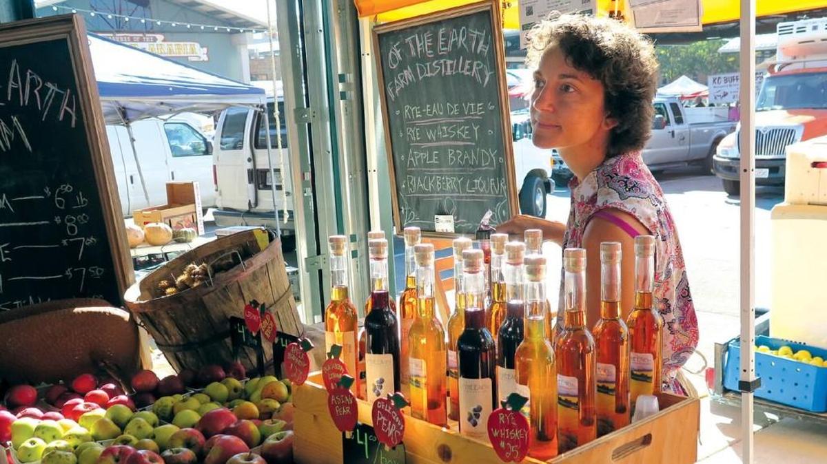 Sarah Burnett Pierce, co-owner of Rayville, Mo.-based Of the Earth Farm Distillery, sells her fruit-based spirits at Kansas City’s River City Market on weekends.
