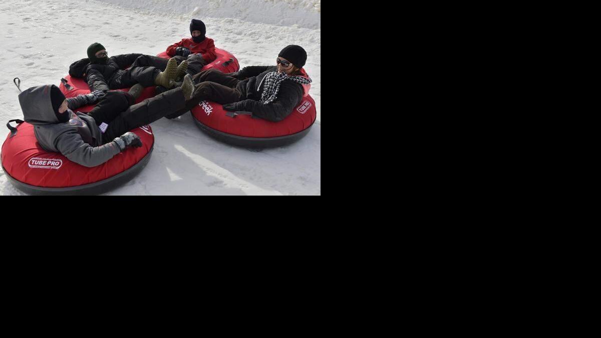 Evan Schoenthal (from left), 11, of Jamestown, Mo.; his cousin Calen Kruger, 11, of California, Mo.; Evan’s twin, Bradley; and mom Jennifer Schoenthal have some family time while tubing.